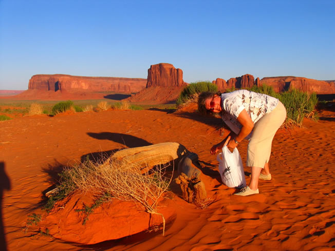 Maria collecting red sand at Monument valley. 